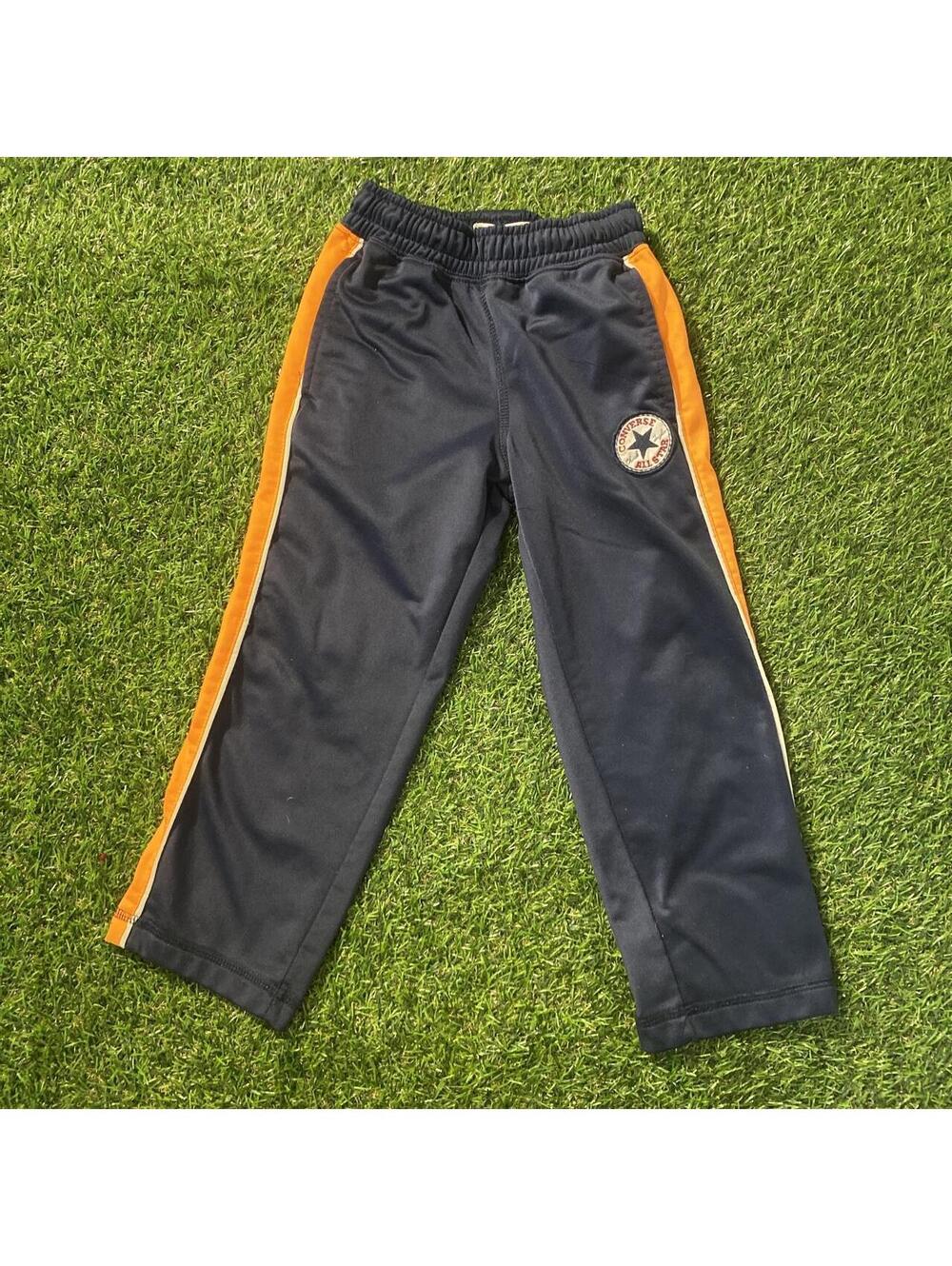 Converse navy blue track pants with orange side stripes